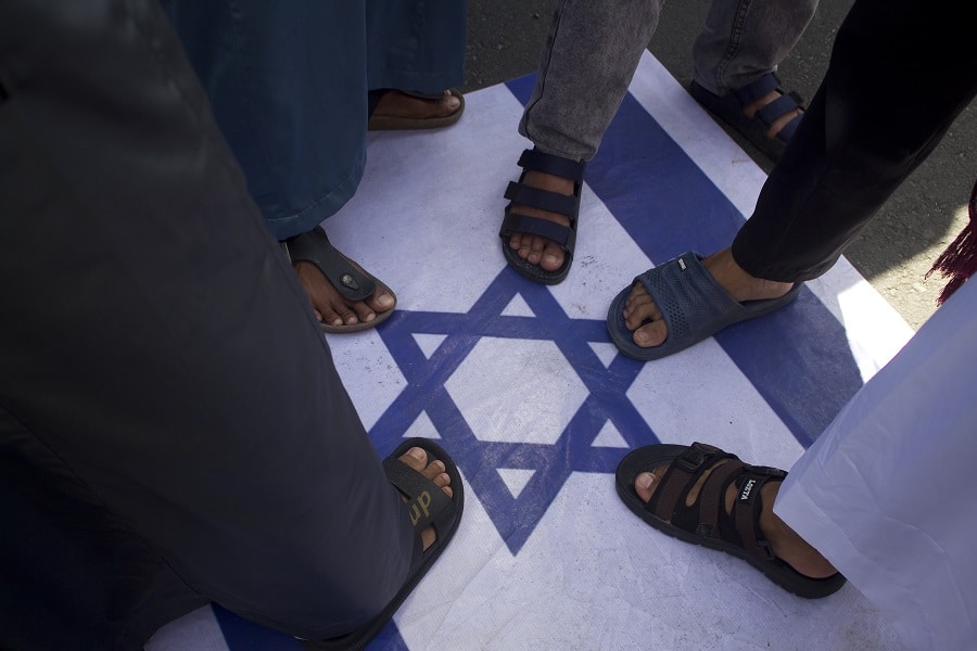 Indonesian protesters stepping on Israeli flags