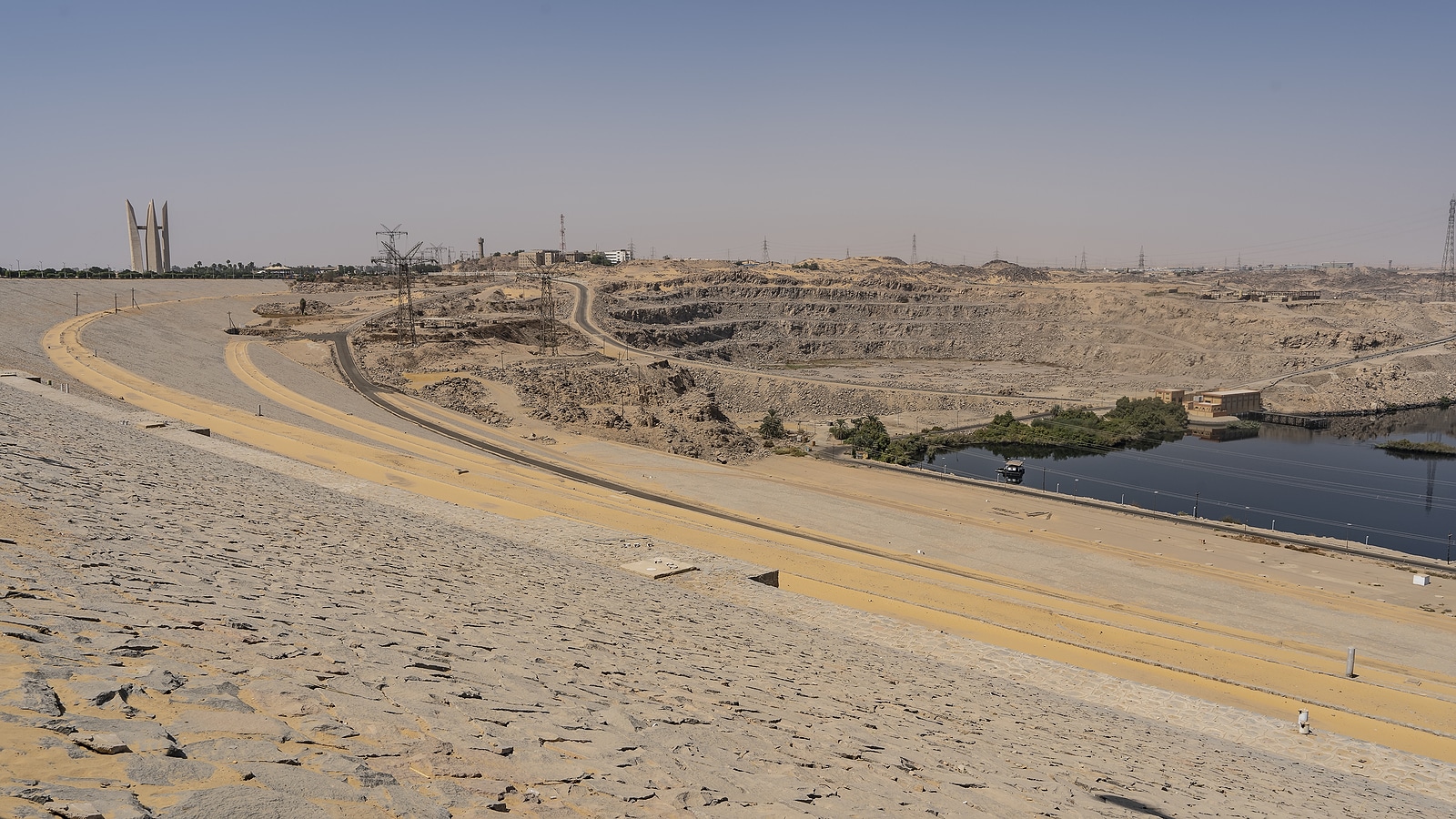 Aswan Dam In Egypt. Sandy-rocky Soil On The Banks Of The Nile, T