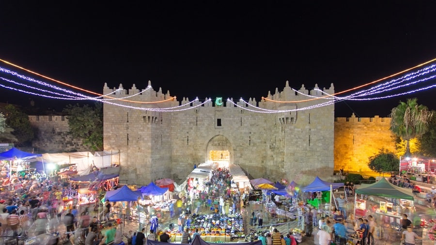 nablus gate at night with colored lights and crowded markets