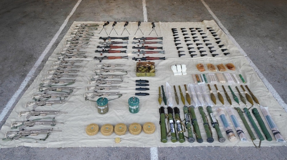 ammunition and weapons spread on white sheets on the floor