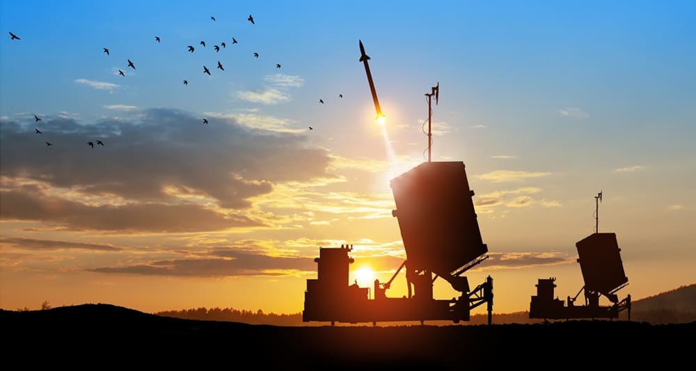 iron dome in action, sunset and birds in the background