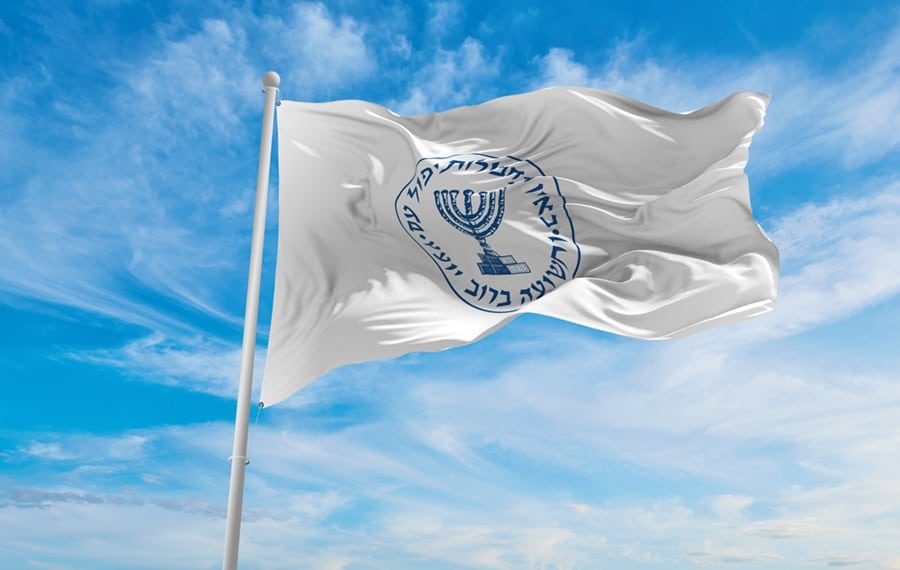 The Mossad flag flies against the sky