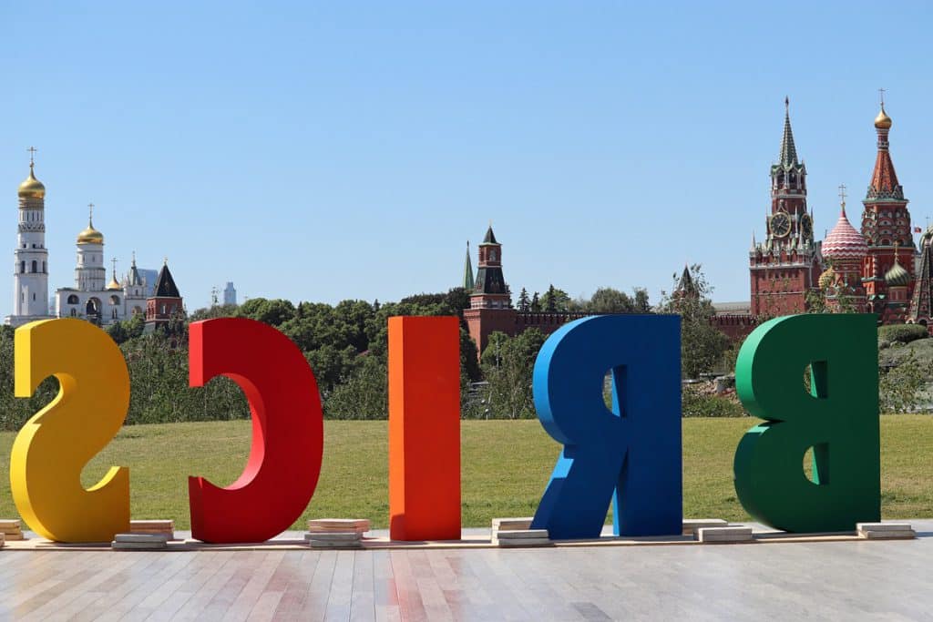 Letters of the abbreviation BRICS installed in the Zaryadye park on background of the Moscow Kremlin
