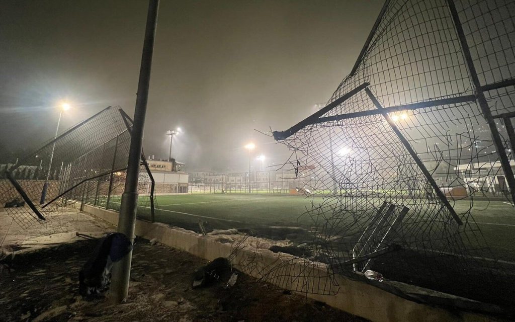 burnt soccer field and broken fence