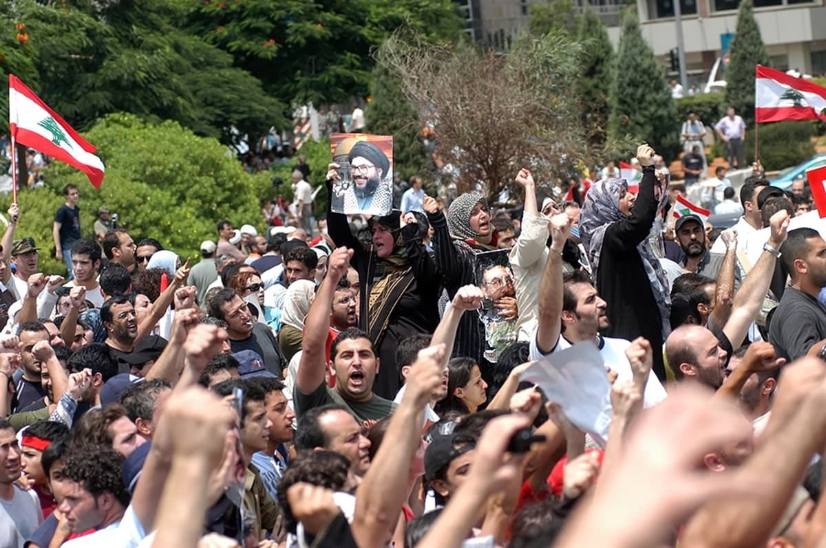 demonstrators with lebanese flags and nassrallah photo