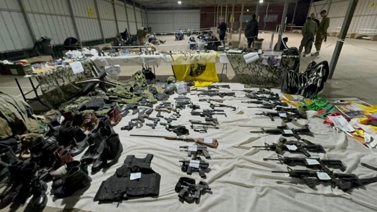 weapons and flags on floor of hanger