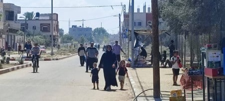 palestinian mother & children walk in streets