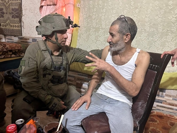 Farhan Qadi sitting with IDF soldier