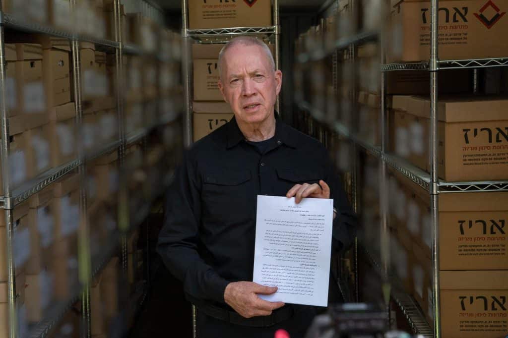 DM Yoav Gallant holding a document