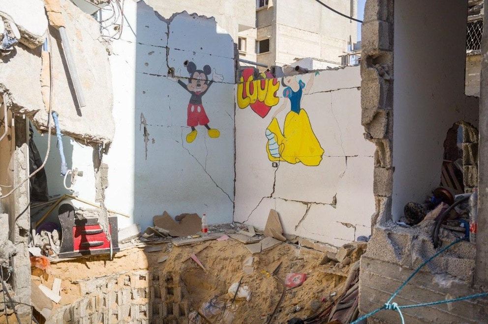 ruined house with micky mouse and snow-white on wall