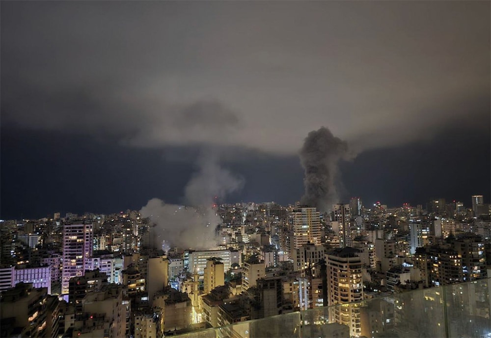 Beirut buildings at night with smoke rising