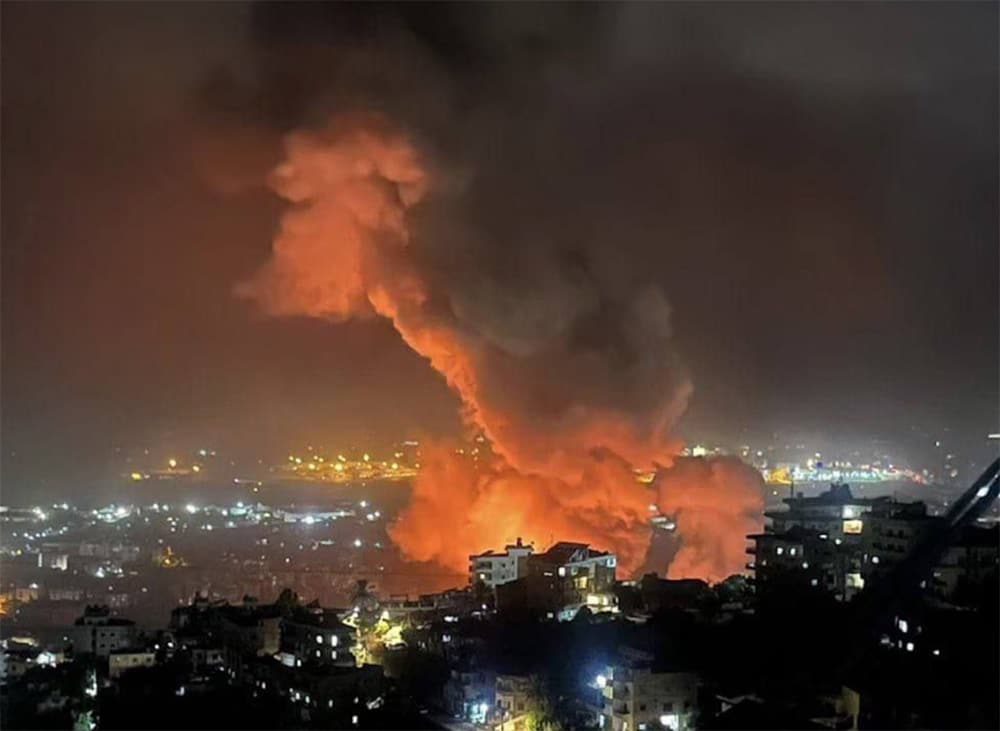 smoke rising over Beirut at night