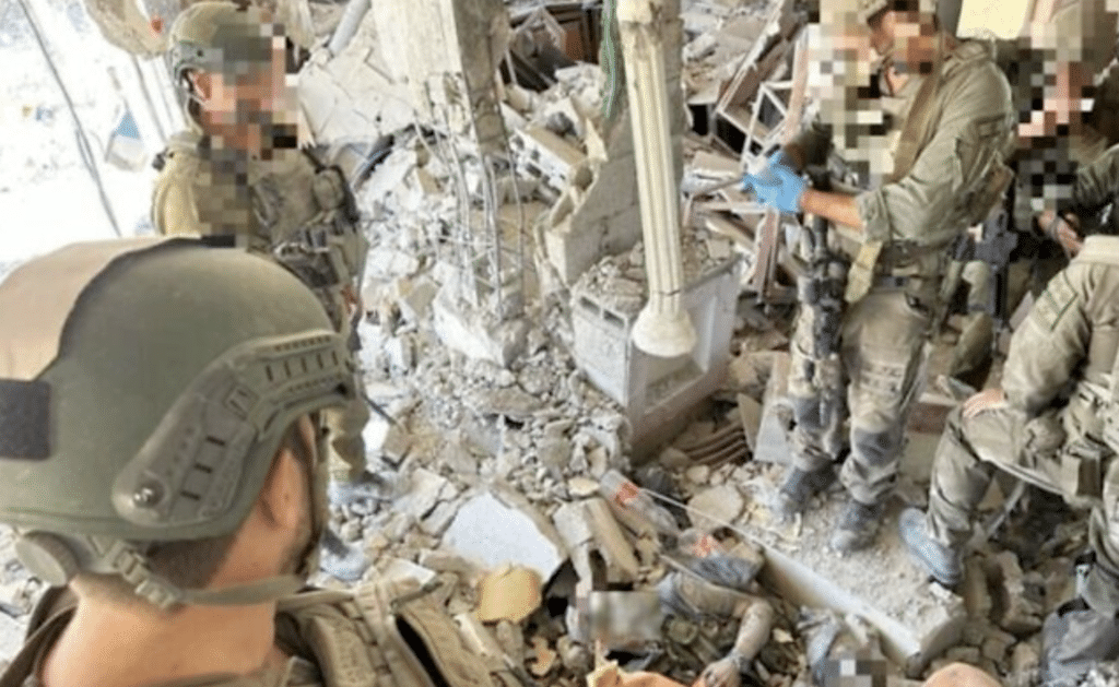 IDF troops stand over the body of Hamas leader Yahya Sinwar