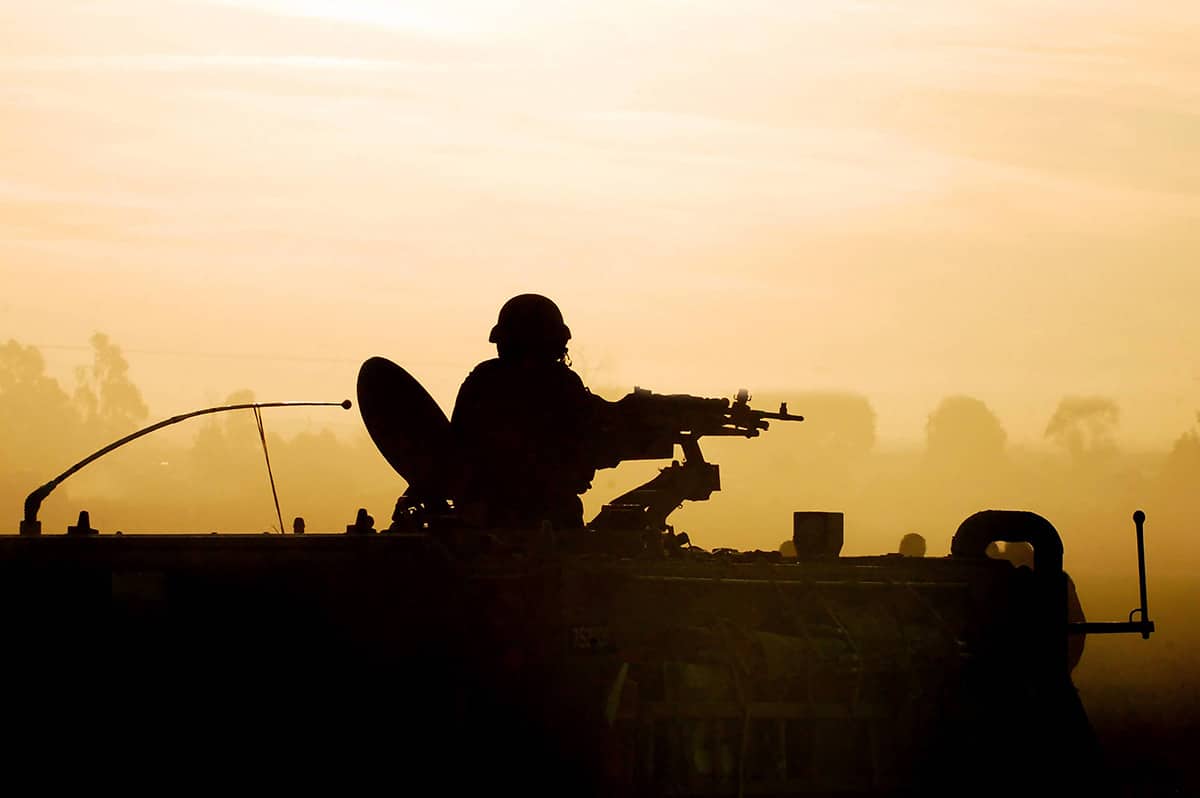 sillhouette of soldier in tank