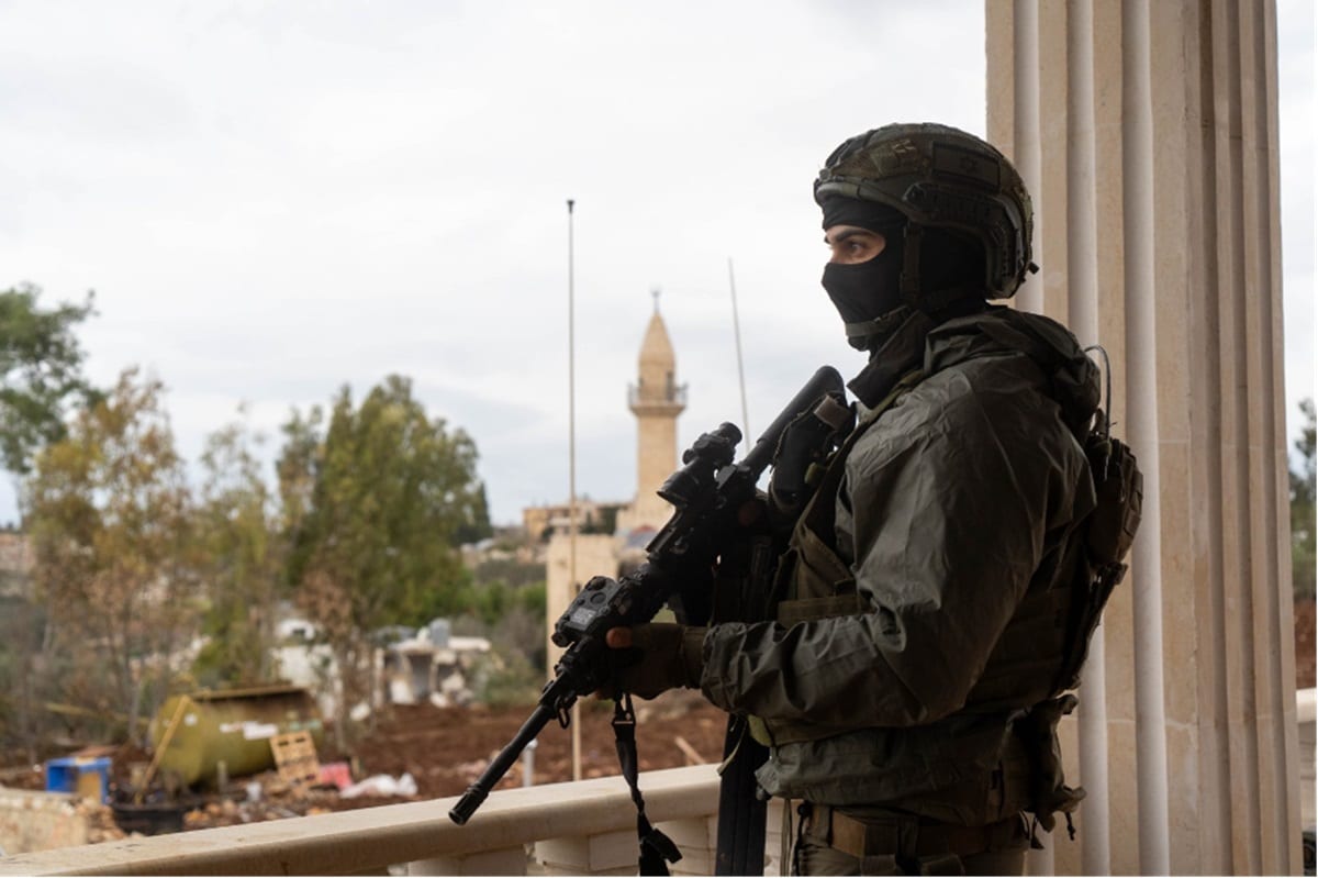 armed IDF sniper watching village