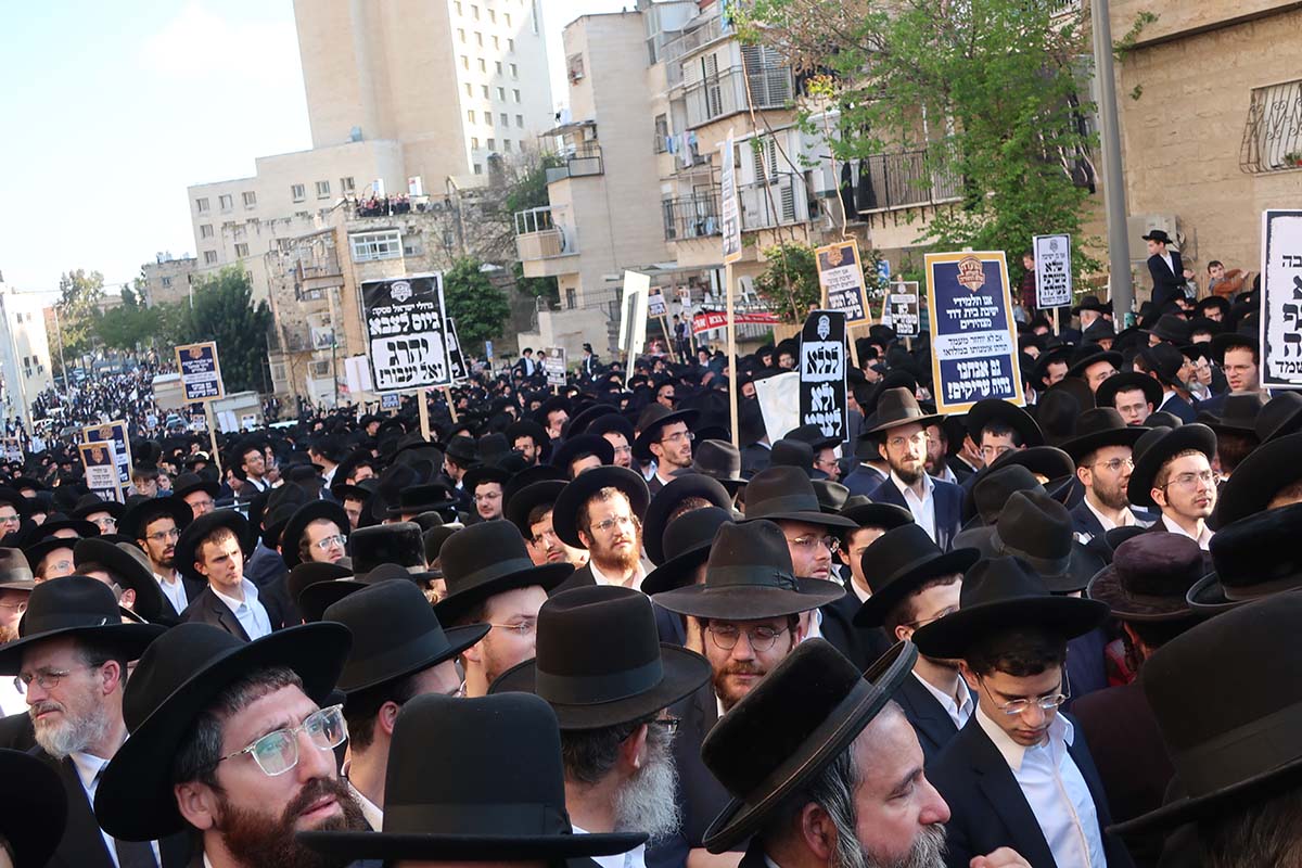 haredim protest against recruitment in streets with signs