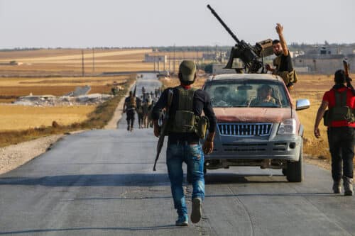 armed rebels in Syria walking on the road