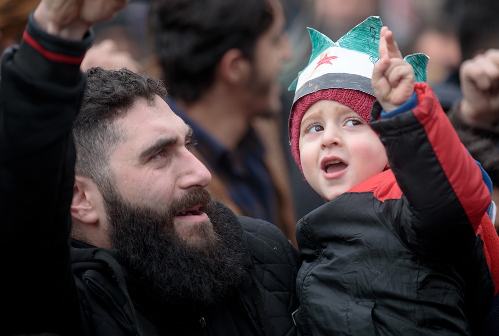 syrian father and toddler signing V with fingers