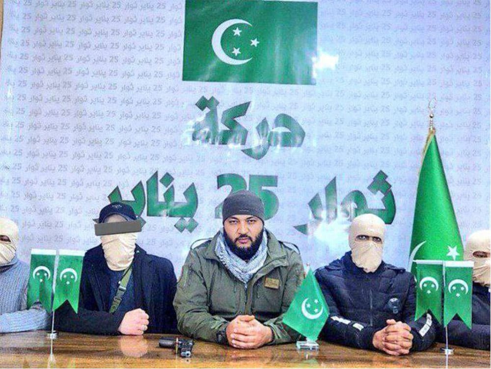 3 members next to table with green flags