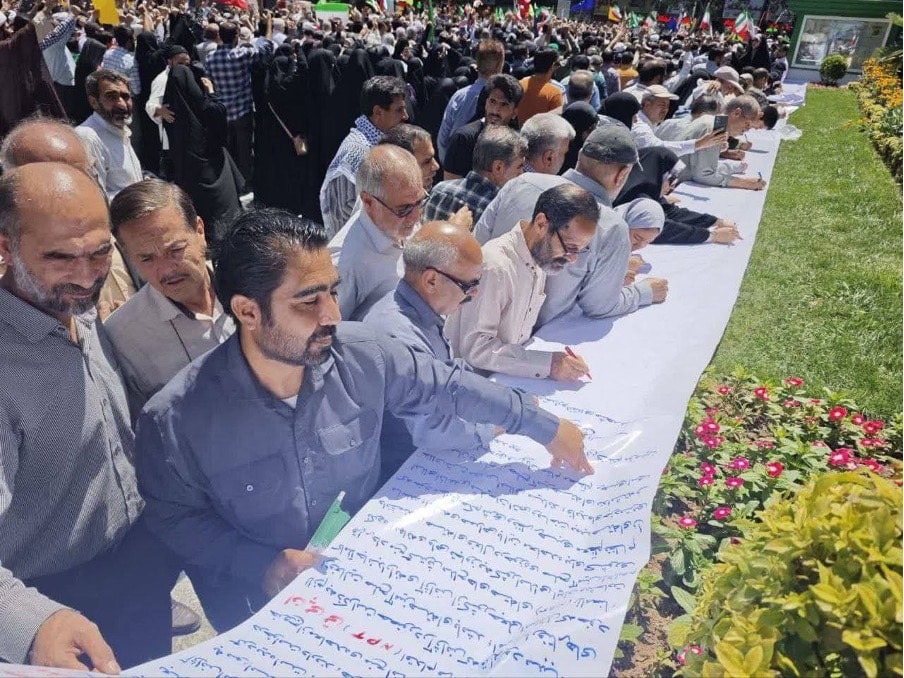 Iranian regime supporters signing a petition calling Iran to withdraw from the NPT
